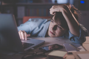 Sleepy Woman Working With Her Laptop